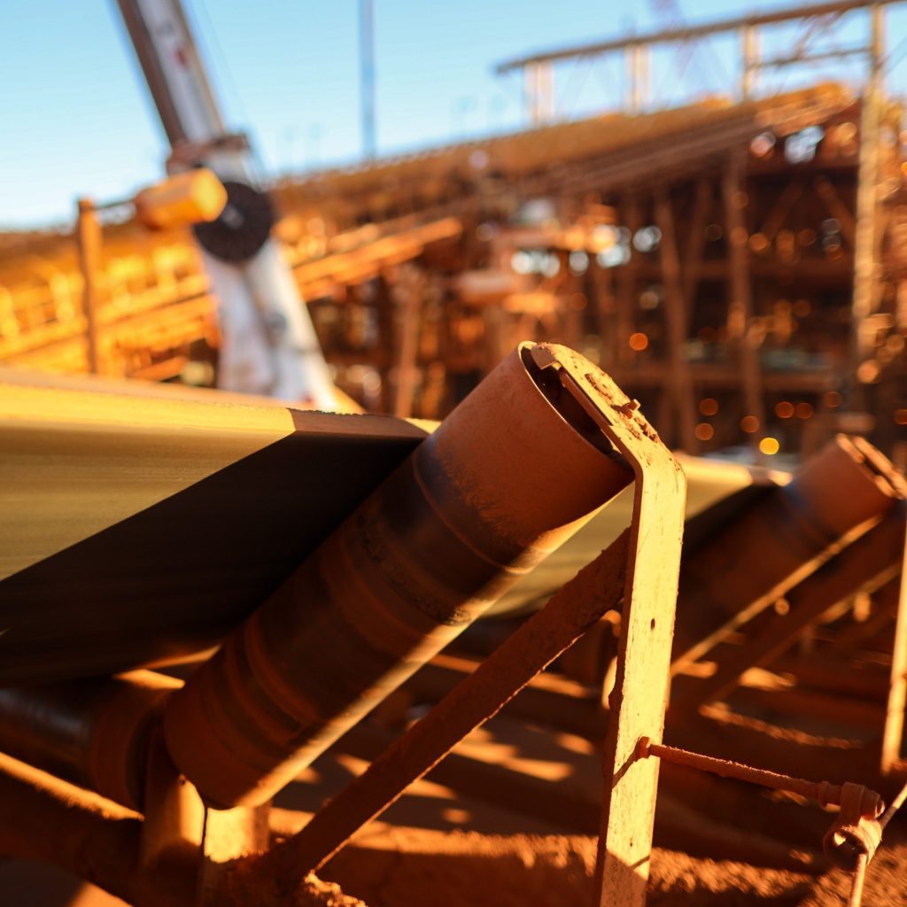 Conveyor belt and rollers structures line its transfer iron ore into material screen house construction mine site, Sydney, Australia